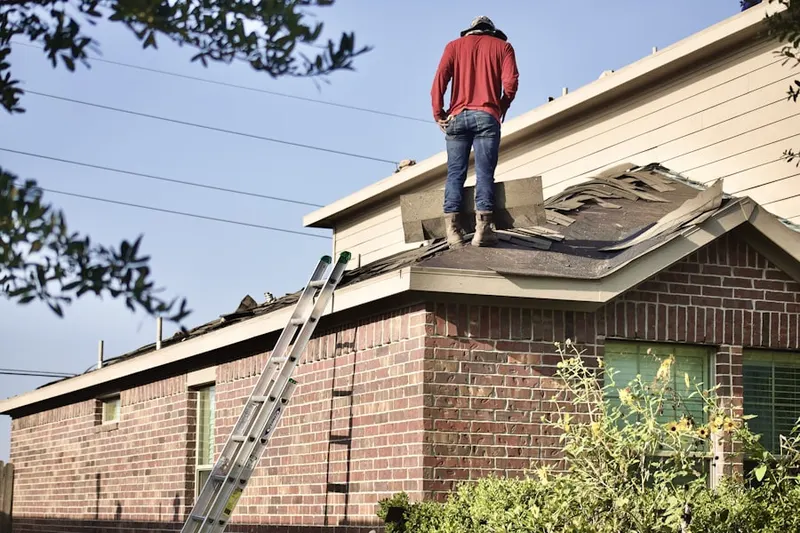 Professional roofer working on a residential roof in Rancho San Joaquin